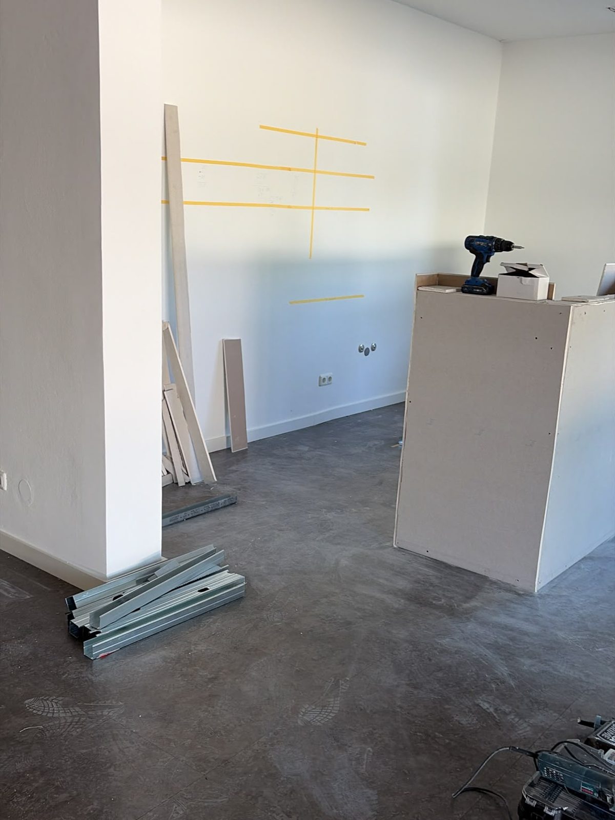 Newly erected walls and markings for the future furnishings of the lounge