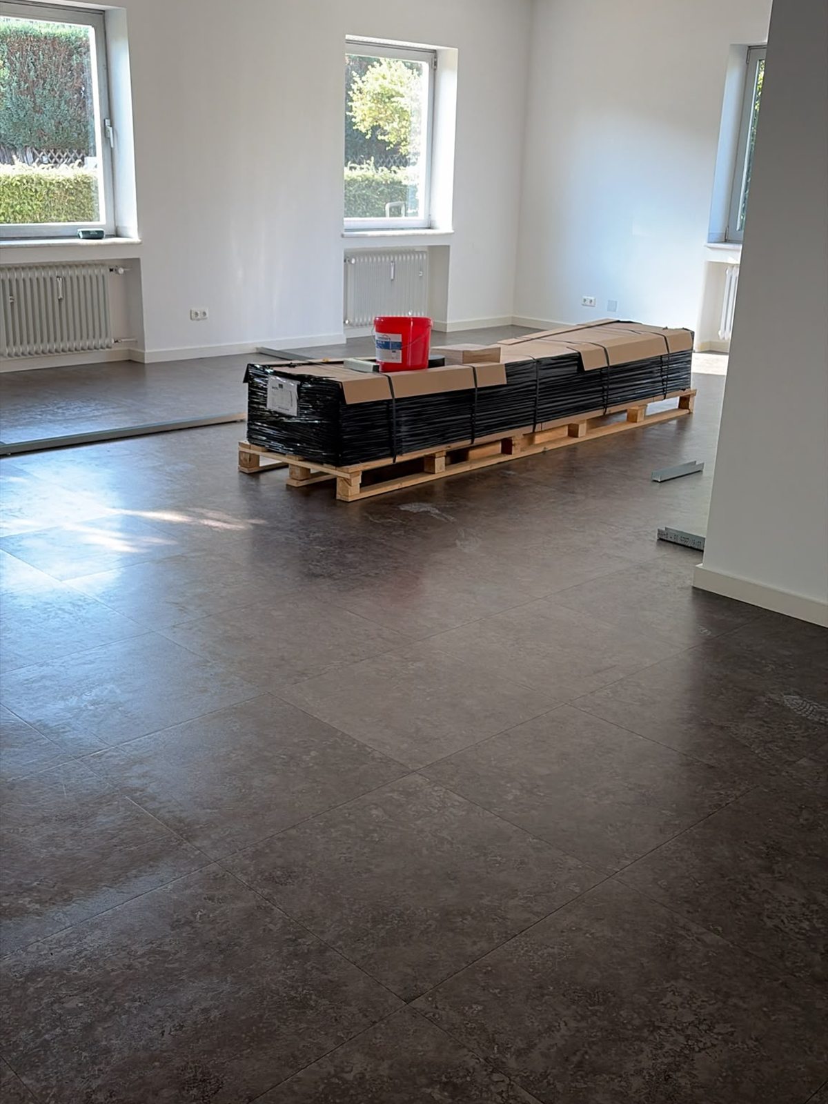 The main room of the lounge with material delivered on pallets